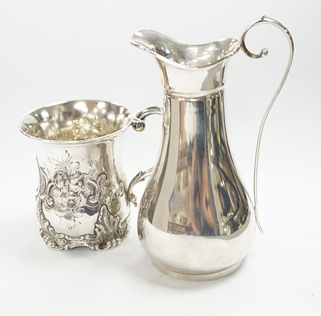 A Victorian embossed silver christening mug, George John Richards, London, 1852, 91mm, together with a later silver jug, 8.5oz. Condition - fair